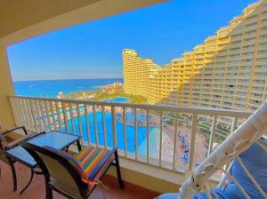 a balcony with a view of the ocean and a resort at Porto Sokhna Marina Towers sea view in Ain Sokhna