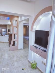 a living room with a flat screen tv on a wall at Porto Sokhna Marina Towers sea view in Ain Sokhna