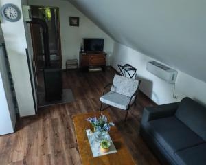 a living room with a couch and a chair at Dudov Hlad in Batina
