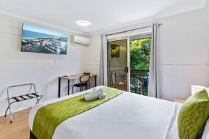 a bedroom with a bed and a balcony at Ingenia Holidays Taigum in Brisbane +108 photos