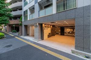a building with a parking lot in front of it at 直达池袋丨东京丨银座无需换乘丨地铁站步行3分钟 丨商店街旁 生活出行方便 in Tokyo