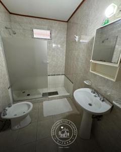 a bathroom with a sink and a toilet and a shower at Lizkar Alojamientos in Esquel +25 photos