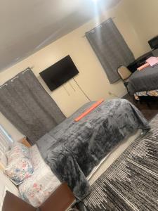 a bedroom with a bed with a blanket on it at Divine Villa 67 Sherman Ave in Newark