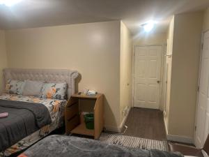 a small bedroom with a bed and a nightstand next to a door at Divine Villa 67 Sherman Ave in Newark
