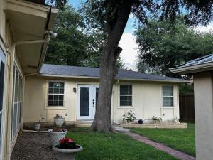 a house with a tree in the yard at Madeira Suite in Fort Worth +7 photos