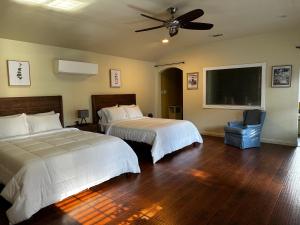 a bedroom with two beds and a ceiling fan at Madeira Suite in Fort Worth