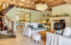 a living room with a couch and a fireplace at Maisons Falourdel in Soulles