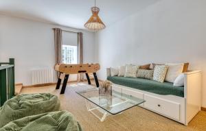a living room with a couch and a table at Maisons Falourdel in Soulles