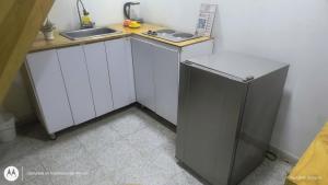 a small kitchen with a sink and a refrigerator at Villa chava mesanine in Ibagué