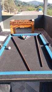 a ping pong table with a ping pong ball on it at Chácara do tio Tuta in Araçariguama