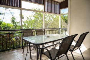 a dining room with a table and chairs on a balcony at seaview apartment in Honiara