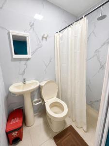 a bathroom with a toilet and a sink at inn house almendros in San Andrés