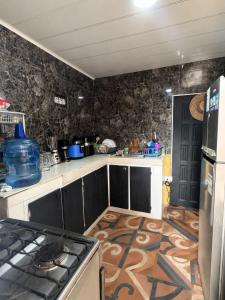 a kitchen with a stove and a counter top at inn house almendros in San Andrés