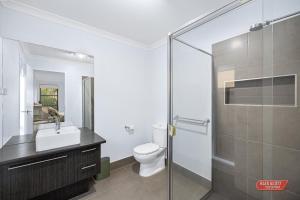 a bathroom with a toilet and a sink and a shower at Getaway on Grampian 2 - 8 guests Pets allowed in Cowes