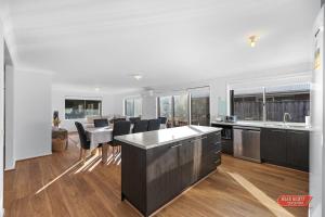 a kitchen and dining room with a table and chairs at Getaway on Grampian 2 - 8 guests Pets allowed in Cowes