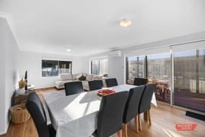 a dining room and living room with a table and chairs at Getaway on Grampian 2 - 8 guests Pets allowed in Cowes +12 photos