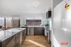 a kitchen with stainless steel appliances and a large window at Getaway on Grampian 2 - 8 guests Pets allowed in Cowes
