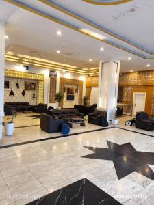 a lobby with couches and tables in a building at فندق سيوار in Erbil