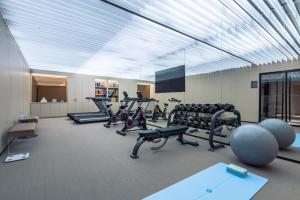 a gym with treadmills and cardio equipment in a room at Crystal Orange Hotel Suzhou Xiangcheng in Suzhou