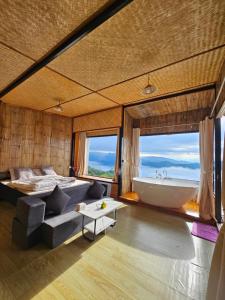 a bedroom with a tub and a bed and a couch at Mon Ngo misty haven B2 in Ban Mae Ta Man