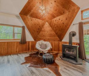 a living room with a chair and a fireplace at Gateway to Glacier in Columbia Falls