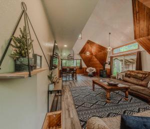 a living room with a couch and a table at Gateway to Glacier in Columbia Falls +20 photos