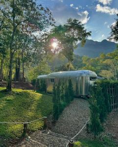 a silver trailer parked in a yard with the sun shining at Sky The Campers in Chiang Dao