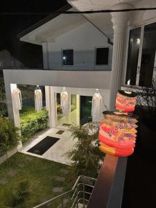 a house with lights on the front of it at La Costa Hotel 15 Min from Airport,Free High-Speed WiFi, Spa Bath, Pool & Restaurant in Katunayaka