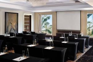 a conference room with tables and chairs and a projection screen at Sankara Nairobi, Autograph Collection in Nairobi +93 photos