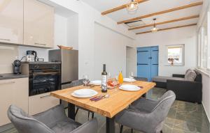 a kitchen and dining room with a wooden table and chairs at Gorgeous Home In Primosten in Primošten