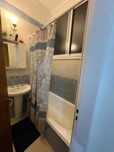 a small bathroom with a sink and a shower at corazón obelisco 2 in Buenos Aires +17 photos