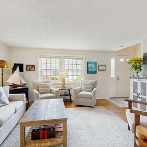 a living room with a couch and chairs and a table at Harborside Retreat in Falmouth
