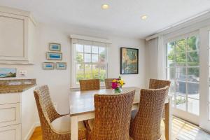 a dining room with a wooden table and chairs at Harborside Retreat in Falmouth
