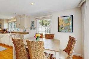 a kitchen with a dining room table and chairs at Harborside Retreat in Falmouth +17 photos