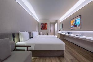a hotel room with two beds and a tv at Crystal Orange Hotel Suzhou Xiangcheng in Suzhou +55 photos