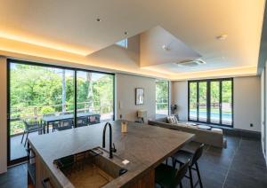 a kitchen and living room with a large window at REQUIES first bloom in Kawazu +45 photos