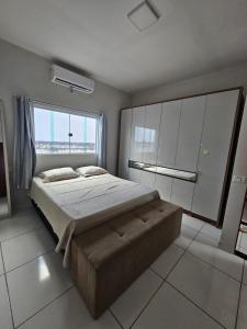 a bedroom with a large bed and a large window at Casa em Piranhas com piscina in Piranhas +15 photos