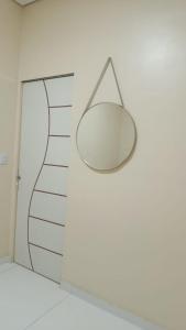 a mirror hanging on a wall in a room at Hospedagem Caripi in Barcarena