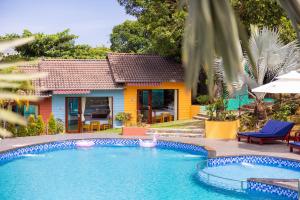 a house with a swimming pool in front of a house at Solivo Ecolodge Phu Quoc in Phú Quốc