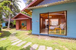 a blue house with a sliding glass door at Solivo Ecolodge Phu Quoc in Phú Quốc
