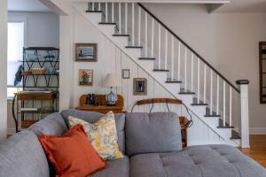 a living room with a couch and a staircase at Maison Marigold ST-2019-0060-R5 in Bloomfield +36 photos