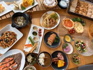 a wooden table topped with lots of different types of food at HOTEL AMANEK Kumamoto in Kumamoto