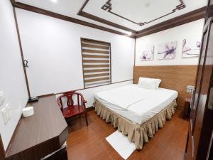a small room with a bed and a window at Khách Sạn Phú Hưng 2 in Hanoi