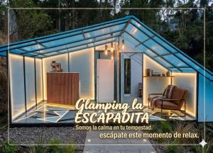 a greenhouse with a refrigerator and a chair in it at Glamping La Escapadita in Baños +27 photos