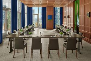 a conference room with tables and chairs and windows at The Times Square EDITION New York in New York