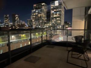 a balcony with a view of a city at night at Downtown Luxury Condo Gym & Parking in Toronto