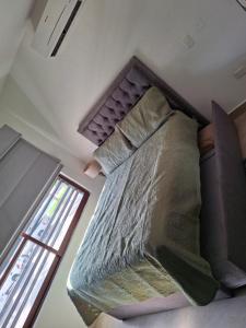 a large bed in a room with a window at Departamento en Mazatlán in Mazatlán +12 photos