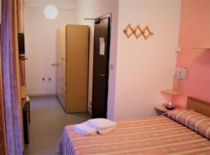 a bedroom with a bed and a door to a hallway at Hotel Midi in Riccione +18 photos