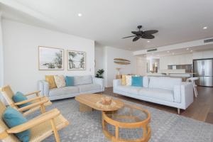a living room with two couches and a table at The Beach Cabarita in Cabarita Beach