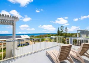 a balcony with chairs and a view of the ocean at Beach Days, Ocean Rooftop & Spa - Sleeps 8 in Marcoola